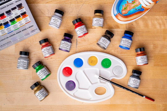 Open box of the Angelus Metallic/Pearlescent kit showing all 12 dazzling paints that create light-reflecting effects on sneakers