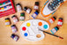 Artist using Angelus Best Sellers paint collection to create custom designs on leather sneakers