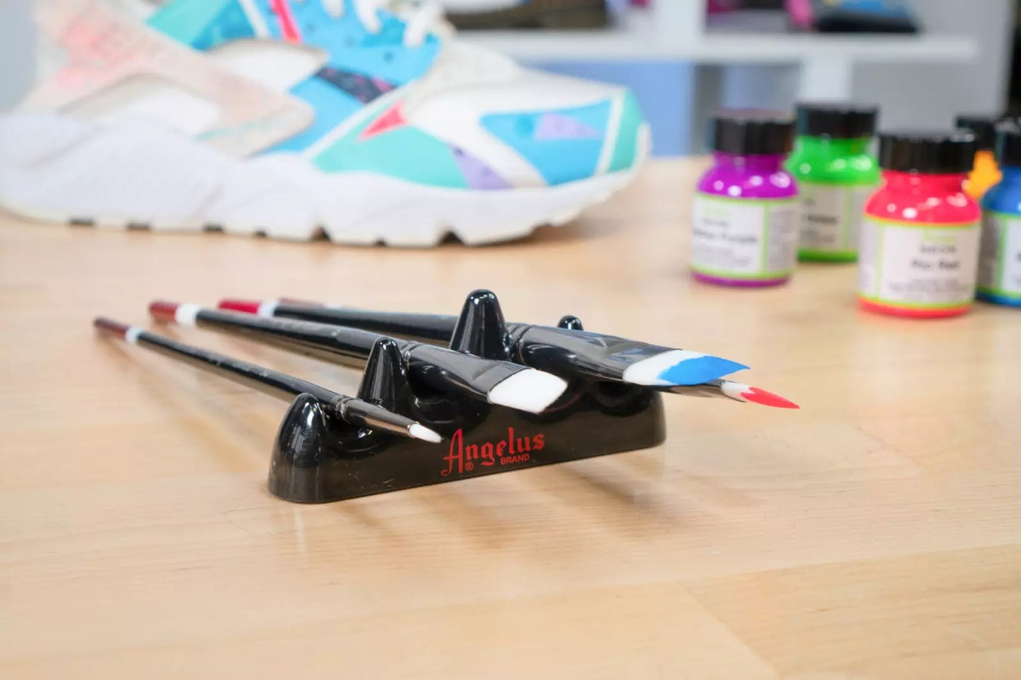 Angelus brush organizer holding multiple detail brushes for sneaker customisation work sessions