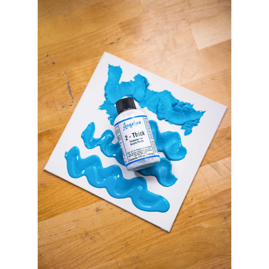 Close-up of impasto technique using Angelus 2-Thick treated paint on leather surface for 3D custom designs