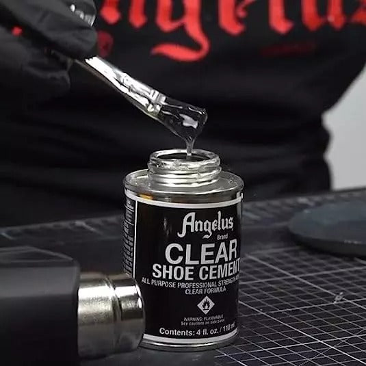 Professional workspace with Angelus Clear Shoe Cement and repair projects showing comprehensive fixing solutions